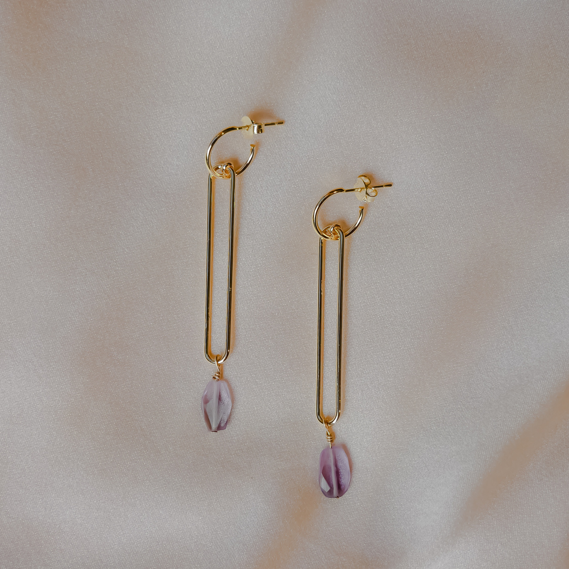 Gold Colored Earrings on White Background